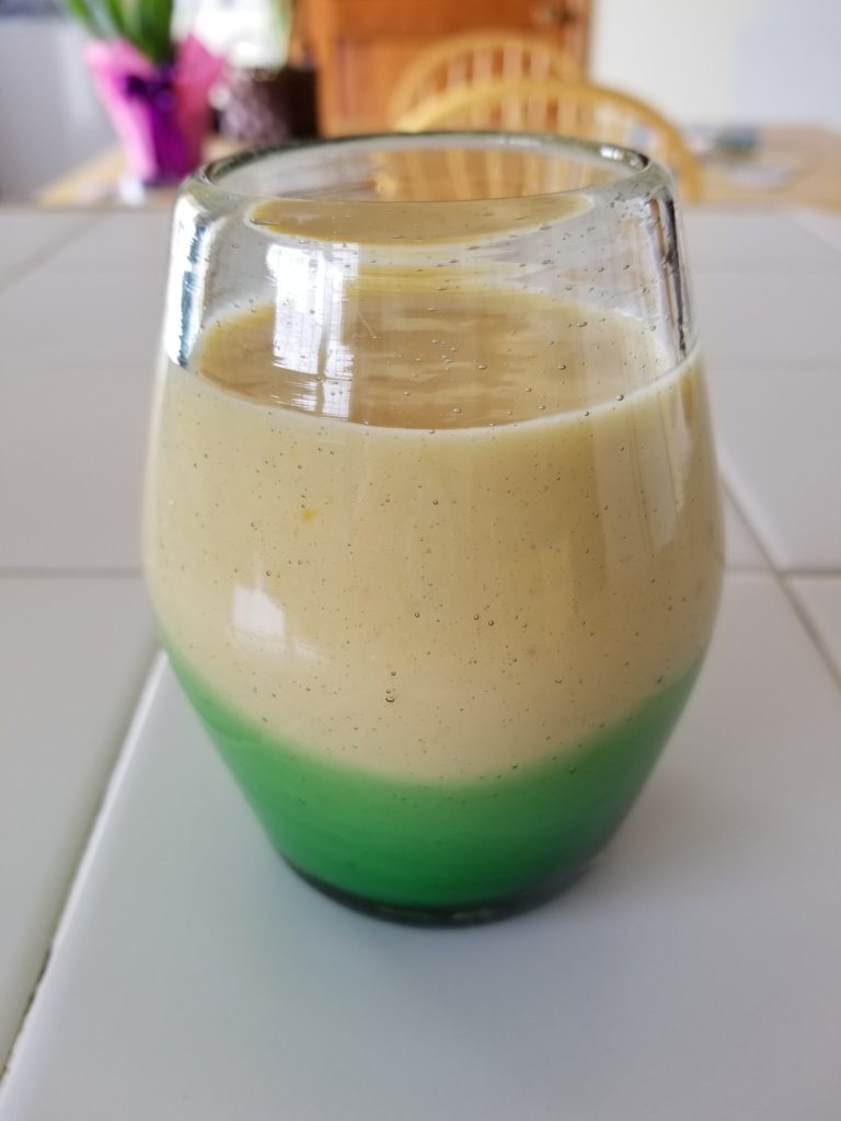green bottom glass filled with smoothie