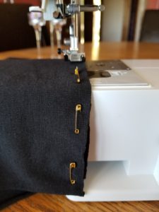 fabric ends pinned with safety pins as a hem